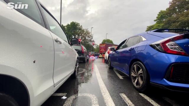 Furious driver snatches Insulate Britain signs & cops free protesters chained together