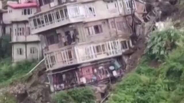 Multi-story building collapses onto other homes