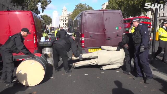 Boris Johnson statue covered in oil blocks Whitehall in eco-protest