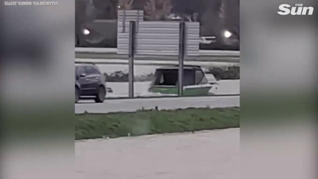 Canada flooding - Boat zips along flooded highways