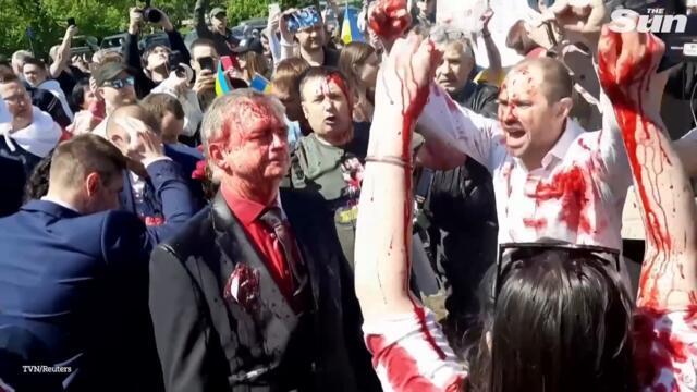 Russian ambassador doused in red by anti-war protesters in Poland