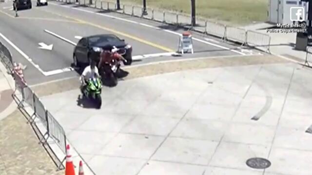 Bystanders and Police Lift Car Off Trapped Motorcyclist
