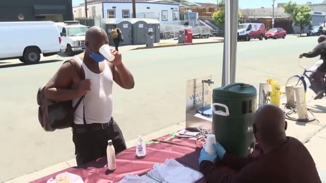 Volunteers Give Water to Homeless During Heat Wave