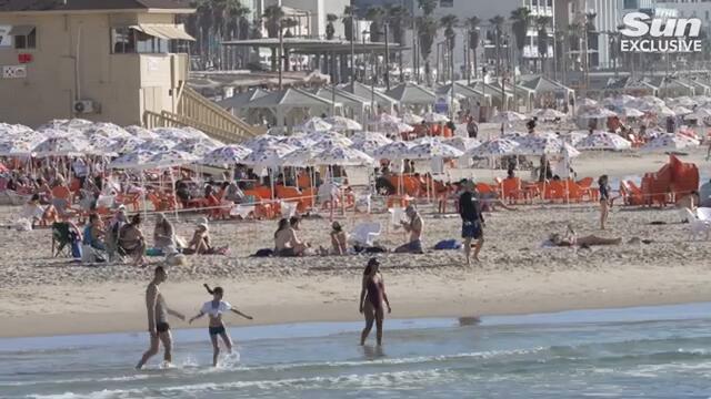 Defiant Israelis relax on beach despite Iran's 181 missile attack